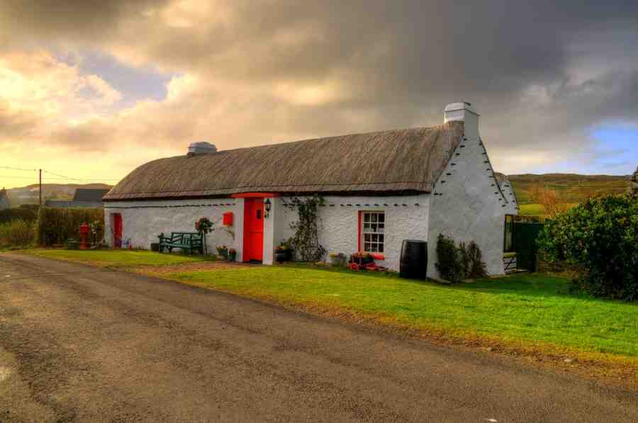 Irish genealogy - An image of an Irish cottage in Galway with a thatched roof showing character and Irish culture